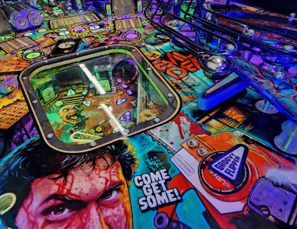 Evil Dead pinball machine, Evil Dead Collector's Edition pinball, Bruce Campbell pinball machine, Limited edition Evil Dead pinball, Spooky Pinball Evil Dead, Horror movie pinball machine, am Raimi Evil Dead pinball, Evil Dead 2 pinball game, Ash Williams pinball machine, Necronomicon pinball feature, Wide-body pinball machine, Motorized pinball toys, Evil Dead vs. other horror pinballs, Collector’s edition pinball cost, Evil Dead pinball machine for sale near me, Pinball expo Evil Dead edition